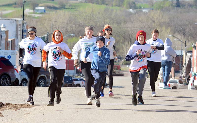 A group of runners take off up Davis Avenue in Corning to start the NHS and student council's color run Saturday in support of the Thirst Project, which helps eradicate world thirst.