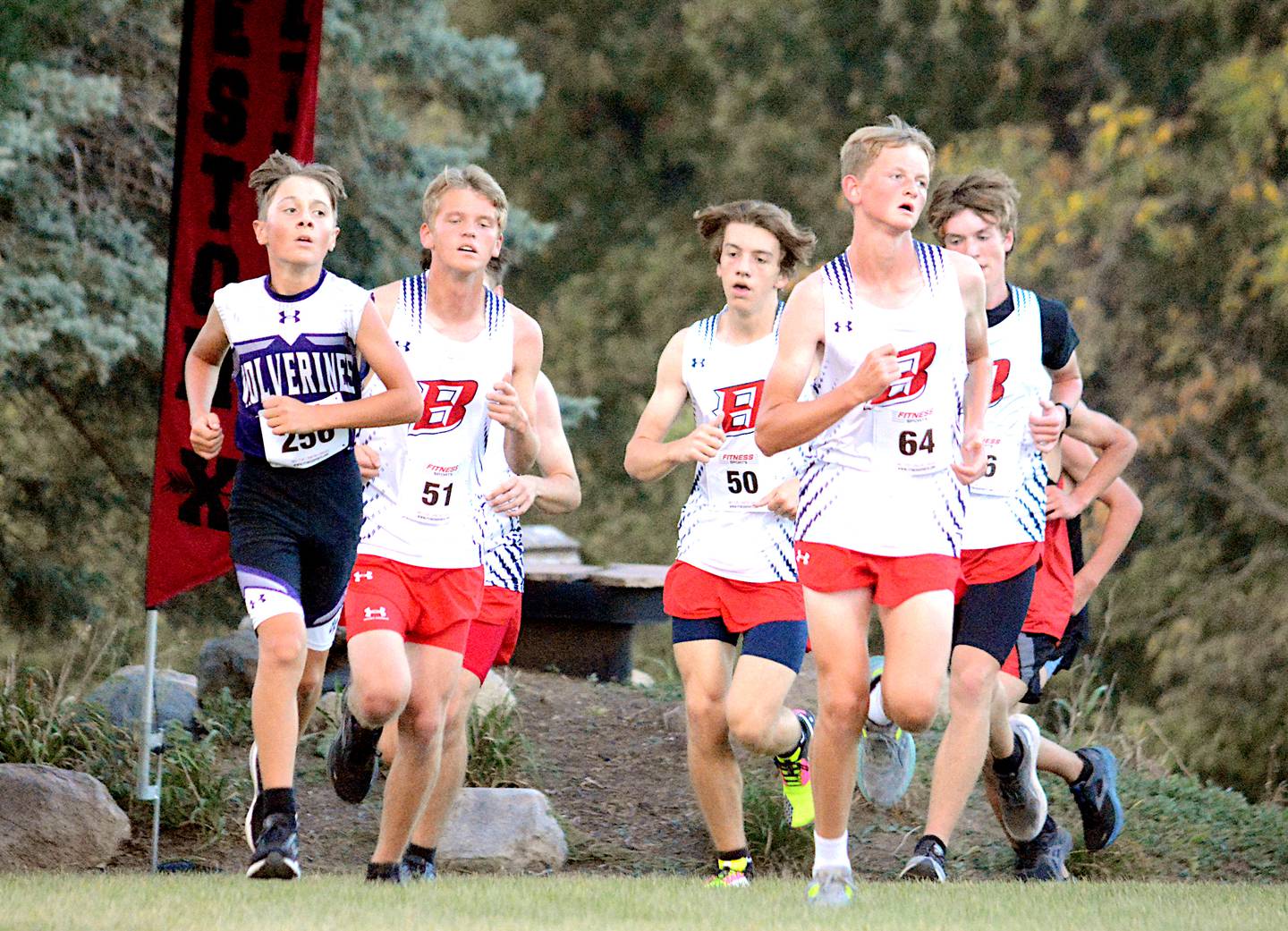 Nodaway Valley's Sam Miller runs with a pack from Ballard in the Winterset cross country meet.