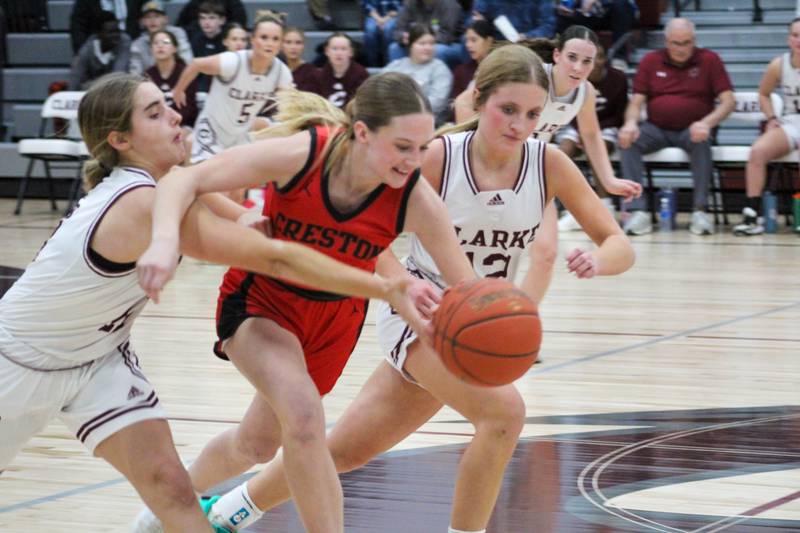 Creston’s Kadley Bailey fights with Clarke players for the ball Tuesday in a 60-27 win over the Indians.