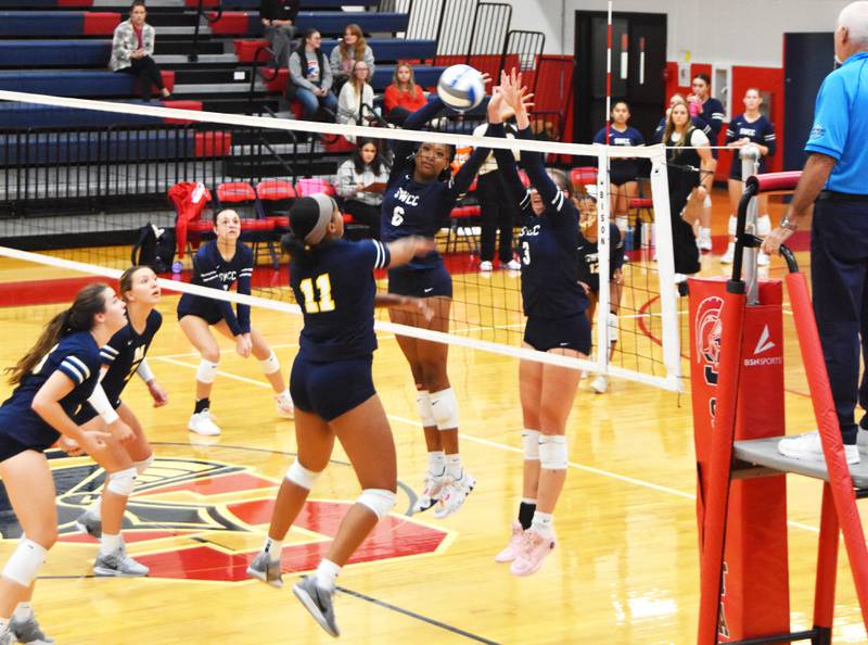 Skyelar Lawal (No. 6) and Audrey Boban (No. 3) get a block against Genesis Melenciano Carela of Marshalltown Tuesday in a 3-1 win at home.