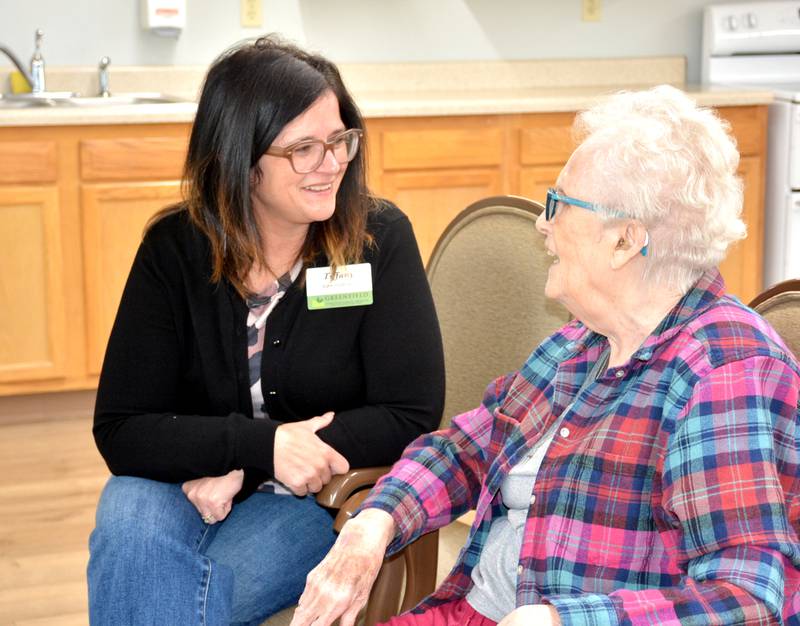 Greenfield Healthcare and Rehabilitation Center Administrator Tiffany Johnson talks with a resident last week at the facility. She began in her new position in February and reports she is enjoying the new challenge.