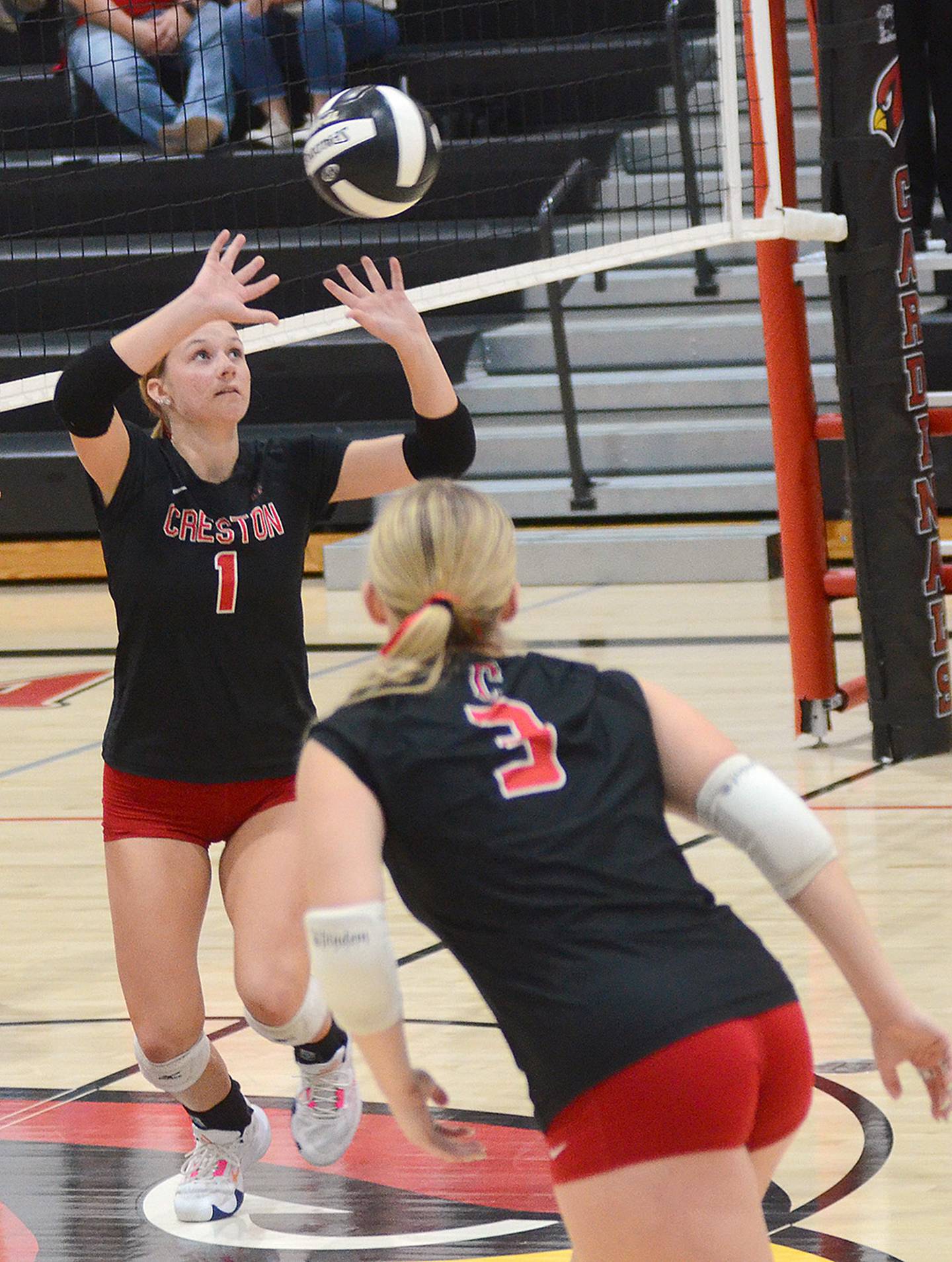 Creston senior Kadley Bailey directs a set as teammate Jaycee Hanson (3) gets into attacking position. Bailey had 32 assists and Hanson had 13 kills in the match.