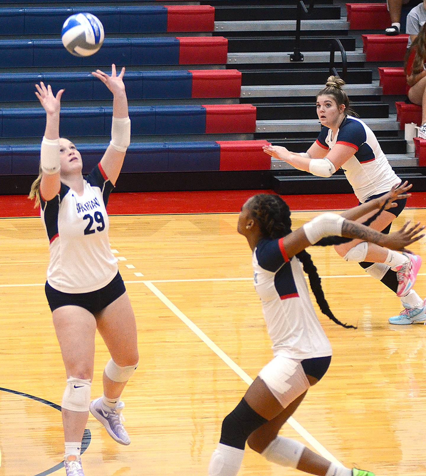 Southwestern's Danica Chamberlain (29) sets the ball as hitters Skyelar Lawal (6) and Danyelle Steinkuehler get into position. Chamberlain, an outside hitter, filled in as setter when Cadence Perkins missed some action with an elbow injury.