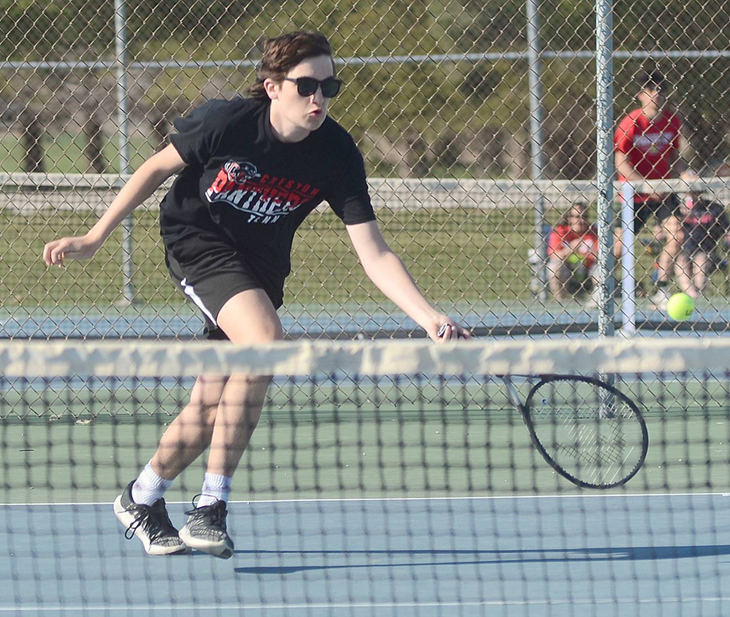Spencer Brown of Creston reaches for a shot near the net during his 8-6 win at No. 6 singles Monday against Chariton.