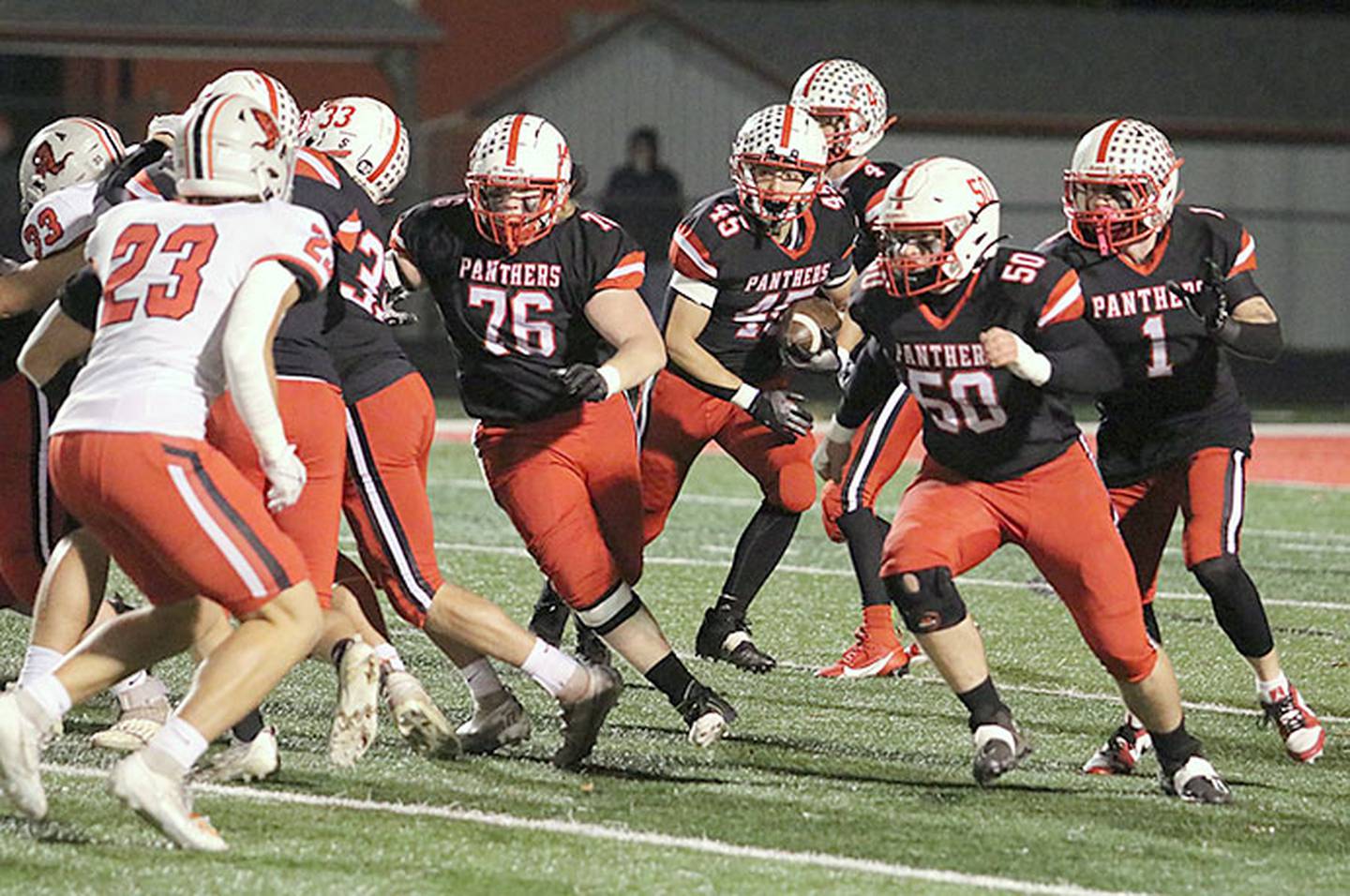 Creston running back Brennan Hayes takes the handoff and follows blockers Carson Rieck (33), Gunner Martwick (76) and Tucker Rohrig (50) against Harlan last week. Also in the backfield are quarterback Cael Turner (4) and running back Weston Trapp (1). Hayes leads Class 3A in all-purpose yardage and is second in rushing with 1,547 yards.