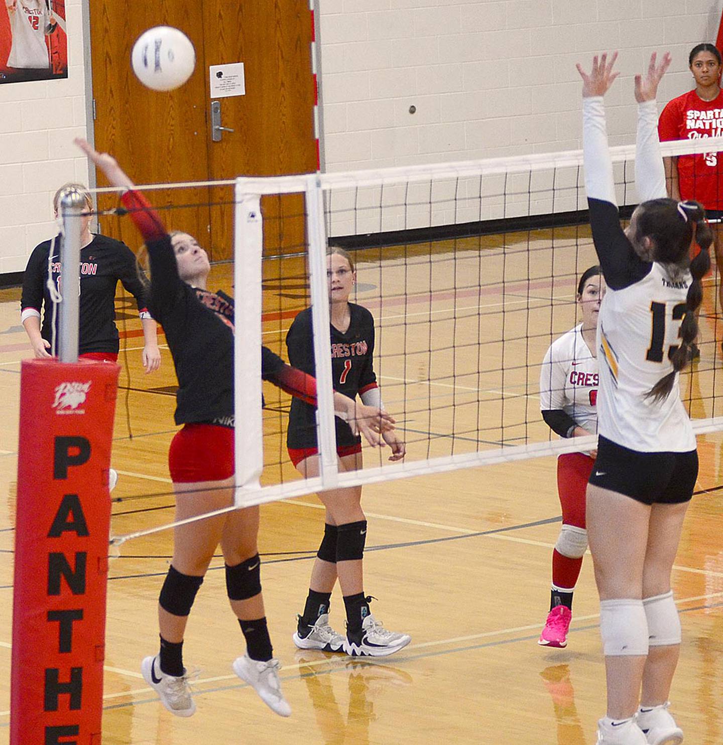 Creston's Ella Turner sends an attack to the Atlantic court Tuesday night against Trojan blocker Paytn Harter. Turner led Creston with seven kills and Harter had a match-high 15 kills for Atlantic.