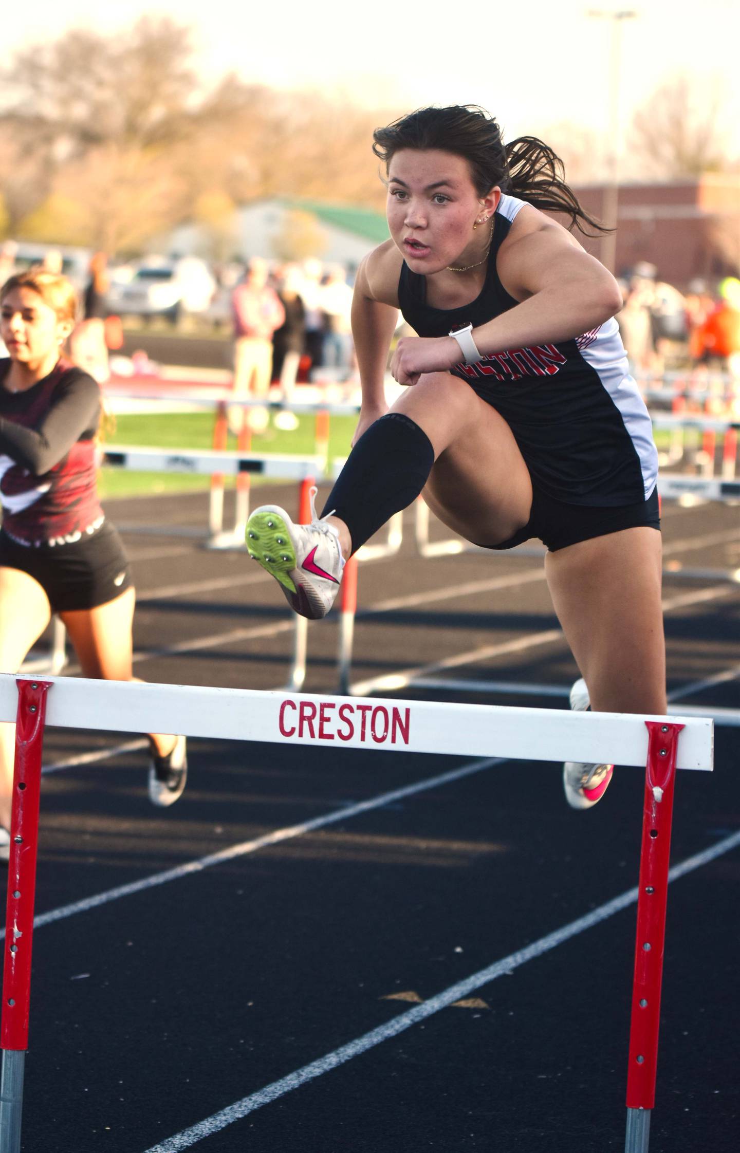 Senior Grace Travis clears a hurdle during the shuttle hurdle relay. Travis is the only senior girl for the Panthers.