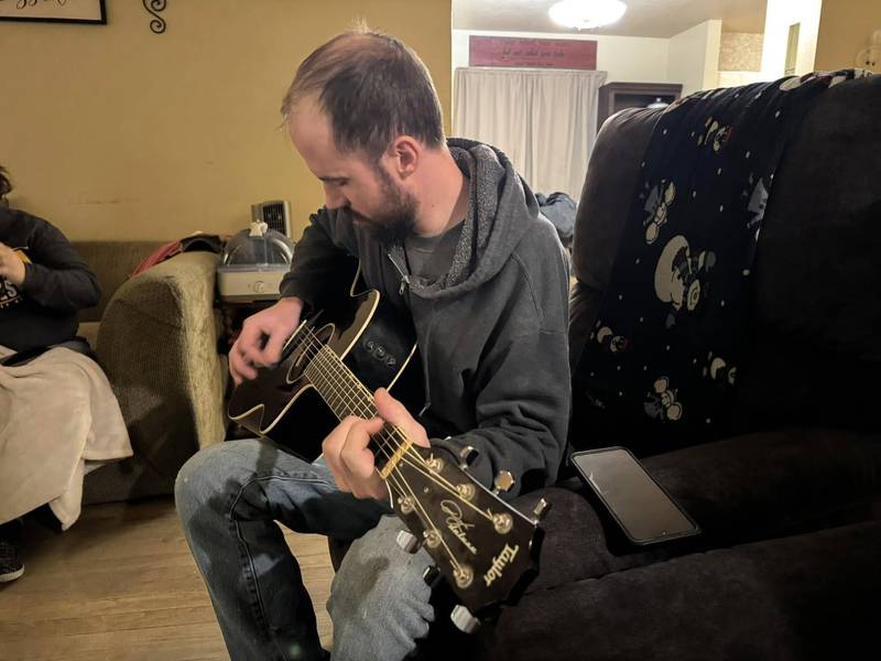 My brother Luke playing guitar in Kilee and my living room in January.