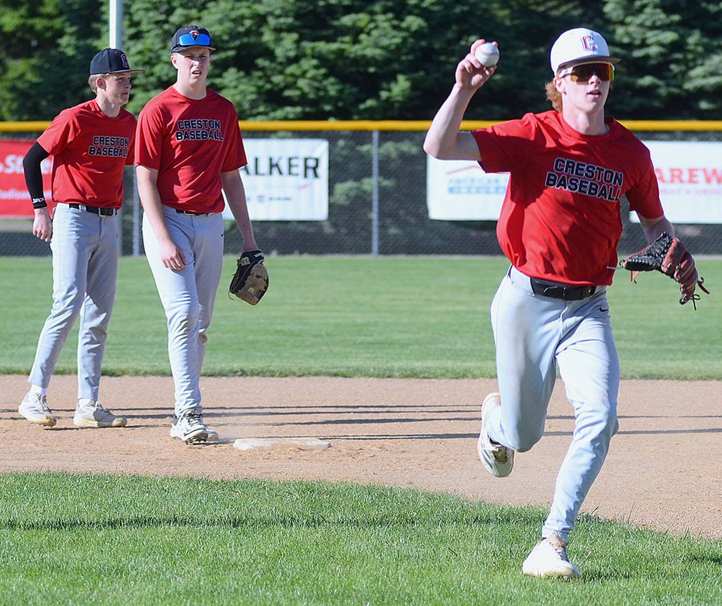 Creston shortstop Tanner Ray practices rundown defense between bases during Wednesday's practice. Ray is also projected as one of the primary starting pitchers for the Panthers.