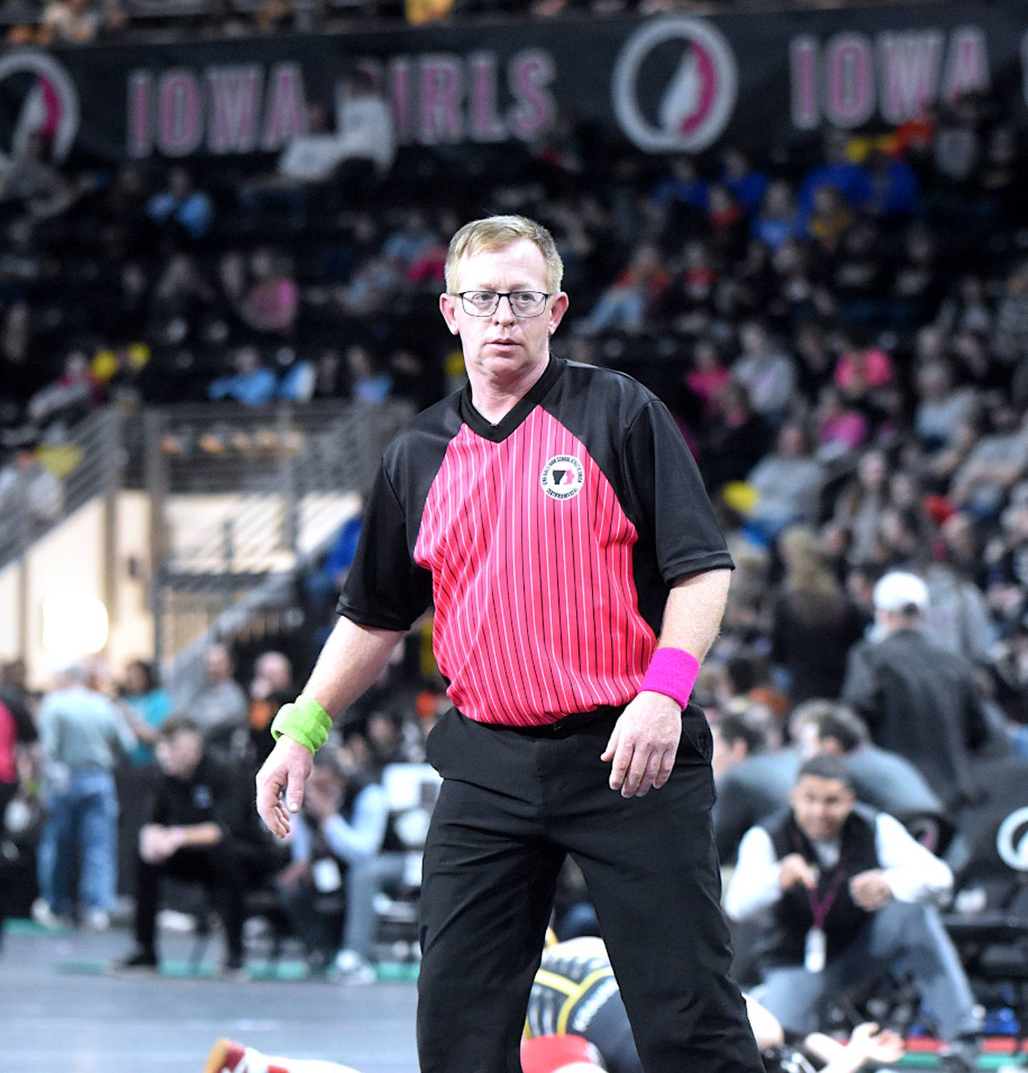 Josh Hamilton watches a match at the 2024 Iowa High School Girls State Wrestling tournament.