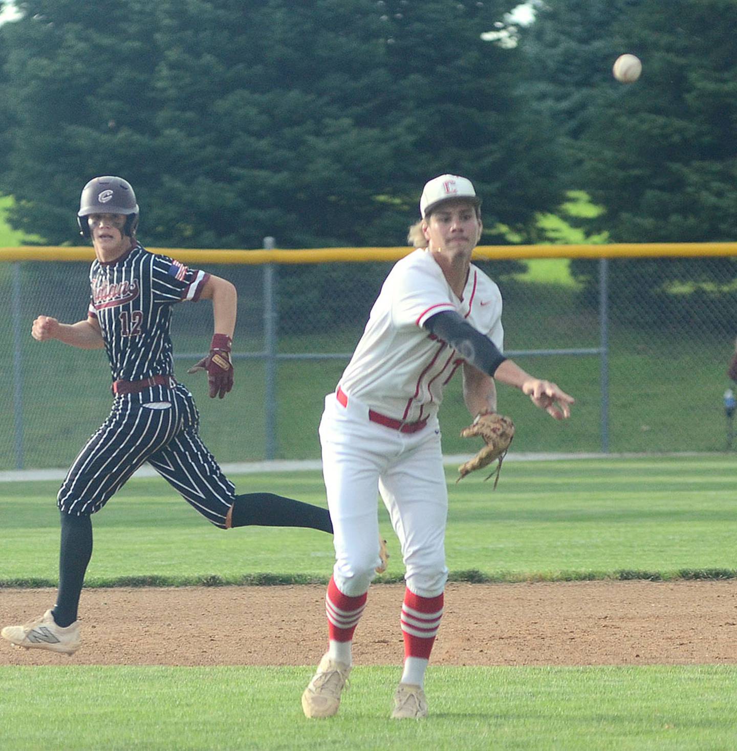 Creston third baseman Camden Smith throws to first base after fielding a ground ball Friday. Smith was one of five seniors on this year's Panther team.