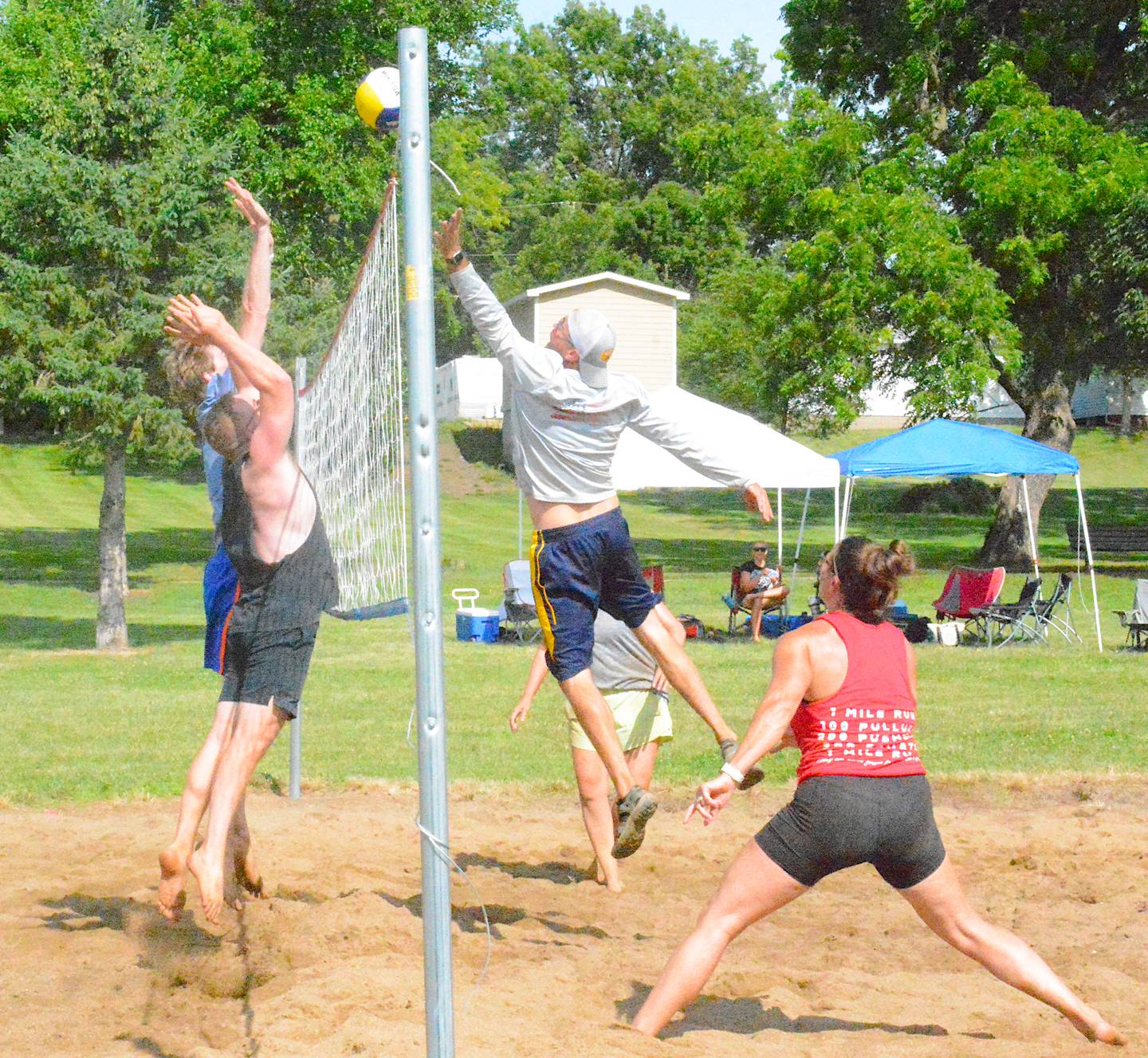 Sand volleyball teams enjoy the sun after a rainy morning Sunday.