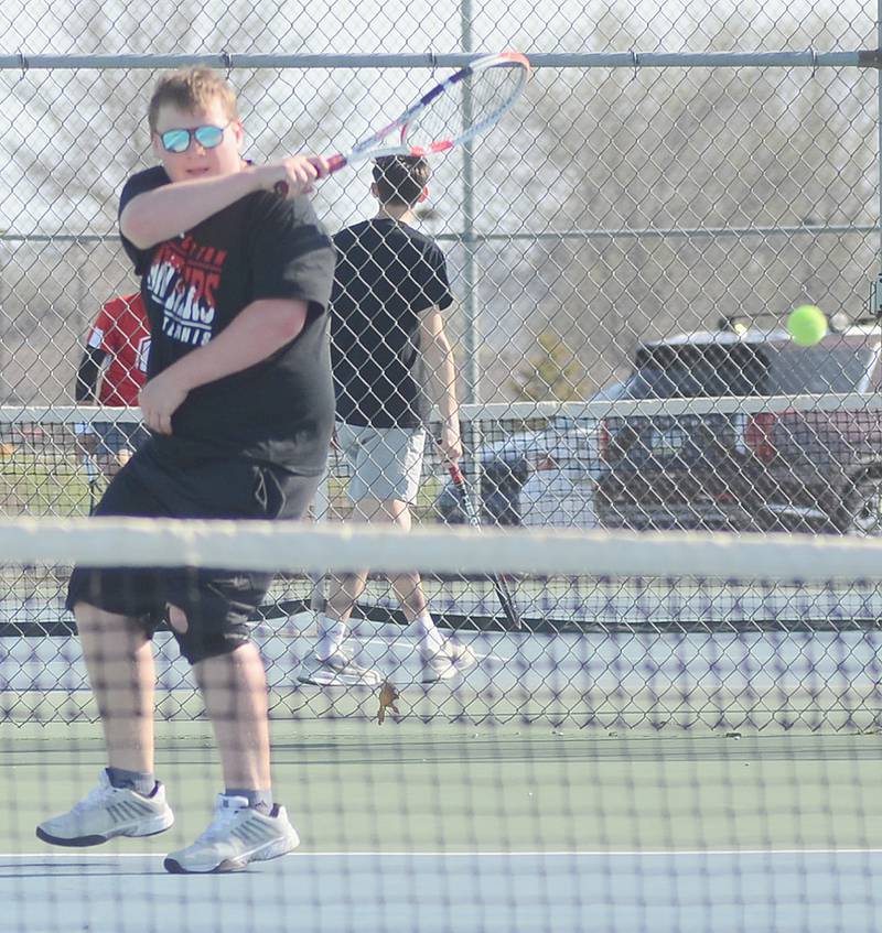 Creston senior Carson Cooper follows through on a baseline shot during his 8-4 singles win against Chariton Monday afternoon.