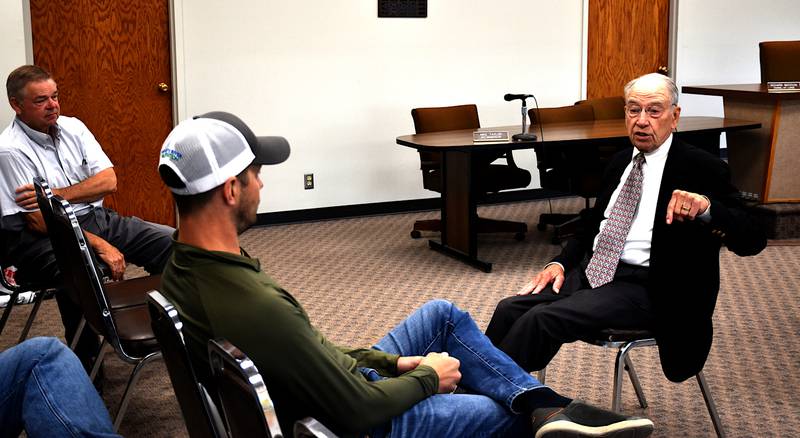 Iowa Sen. Charles Grassley, right, meets with Creston officials Monday in Creston City Council chambers.