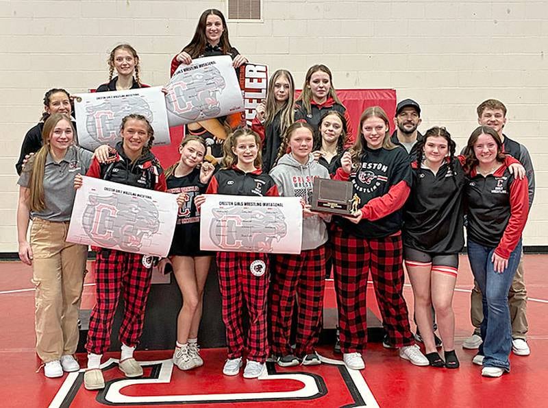 The Creston girls wrestling team holds the championship trophy from Friday's Panther Invitational. The Panthers scored 145.5 points to surpass runner-up Clarinda with 136 points.