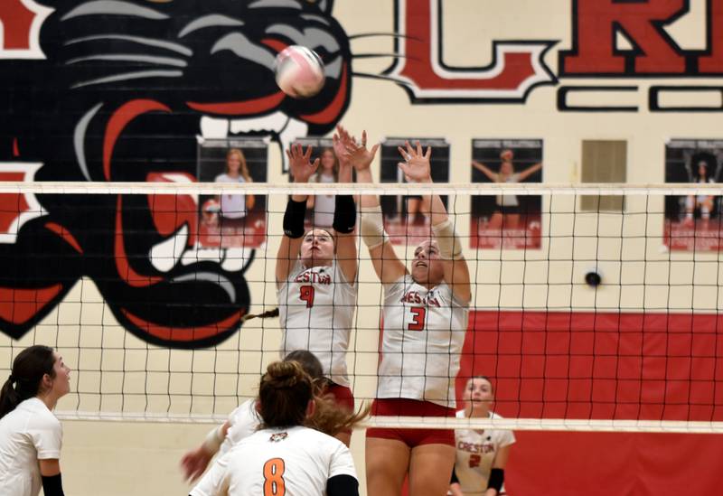 Hope Henderson (No. 9) and Jaycee Hanson (No. 3) go up for a block in the third set against the Tigers.