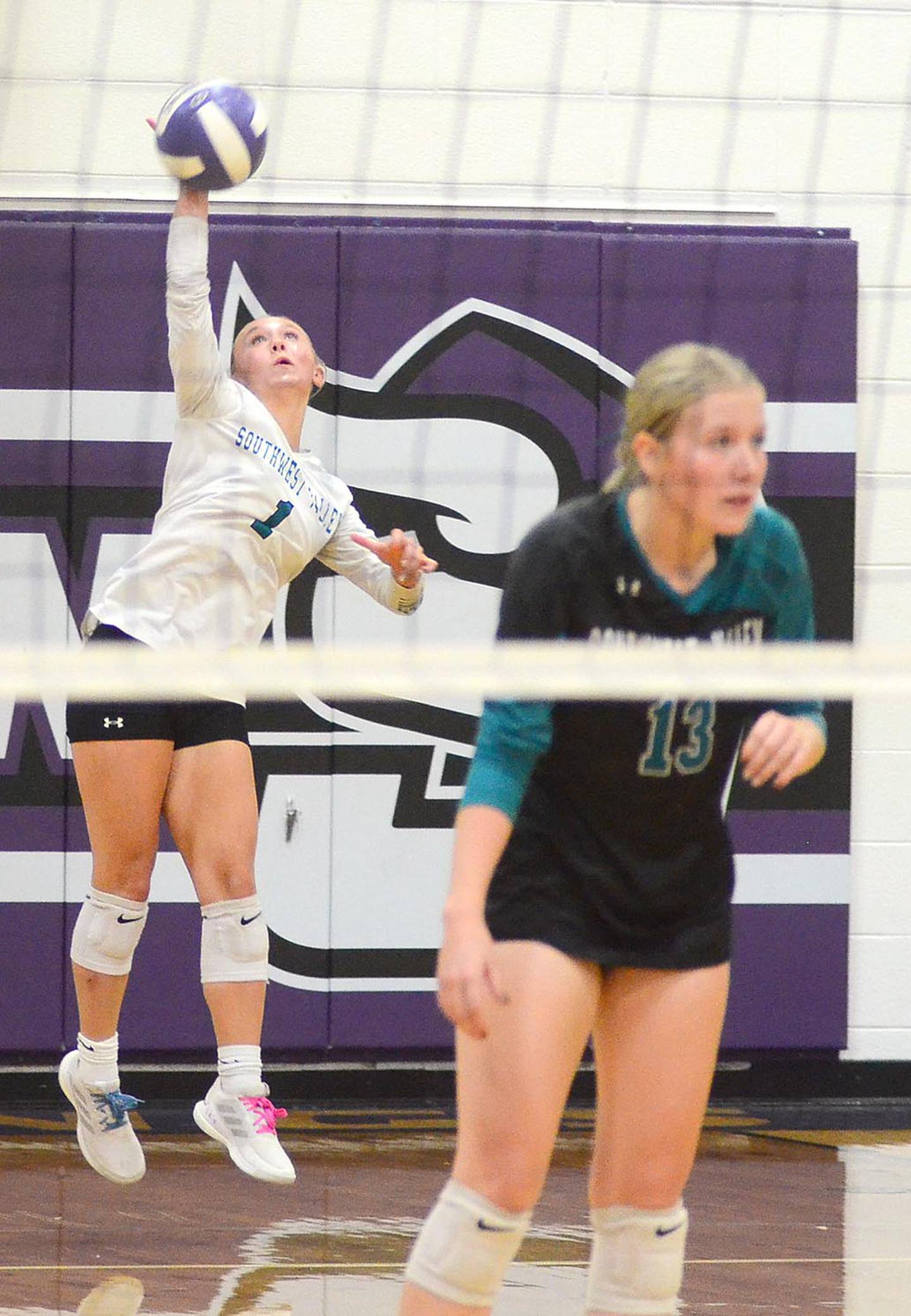 Southwest Valley libero Ada Lund sends a serve to the Stanton court as teammate Maddie Bevington (13) stands ready for the return. Lund had 14 digs and Bevington had a team-high 21 digs.