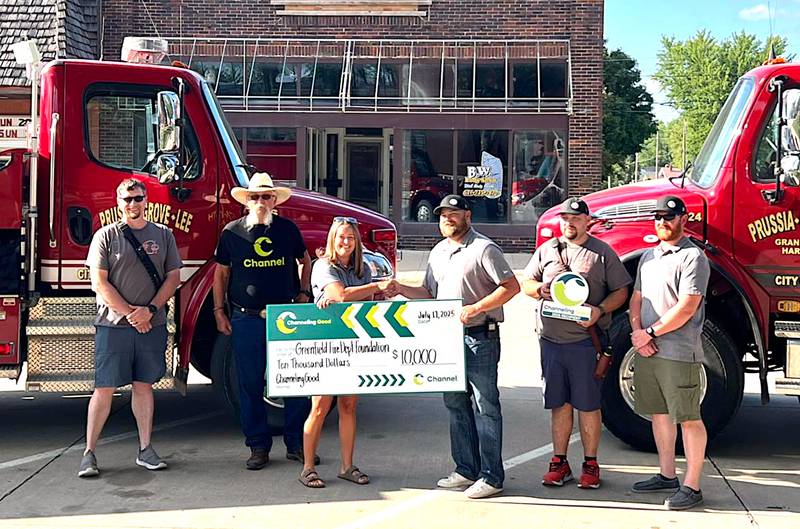 Receiving a $10,000 check from Channeling Seeds' Channeling Good program, presented by Jamie Smith and Dennis Dukes, are Greenfield firefighters Rocky Merritt, Lance McFarland, Fire Chief Curtis Vry and Brett Stender.