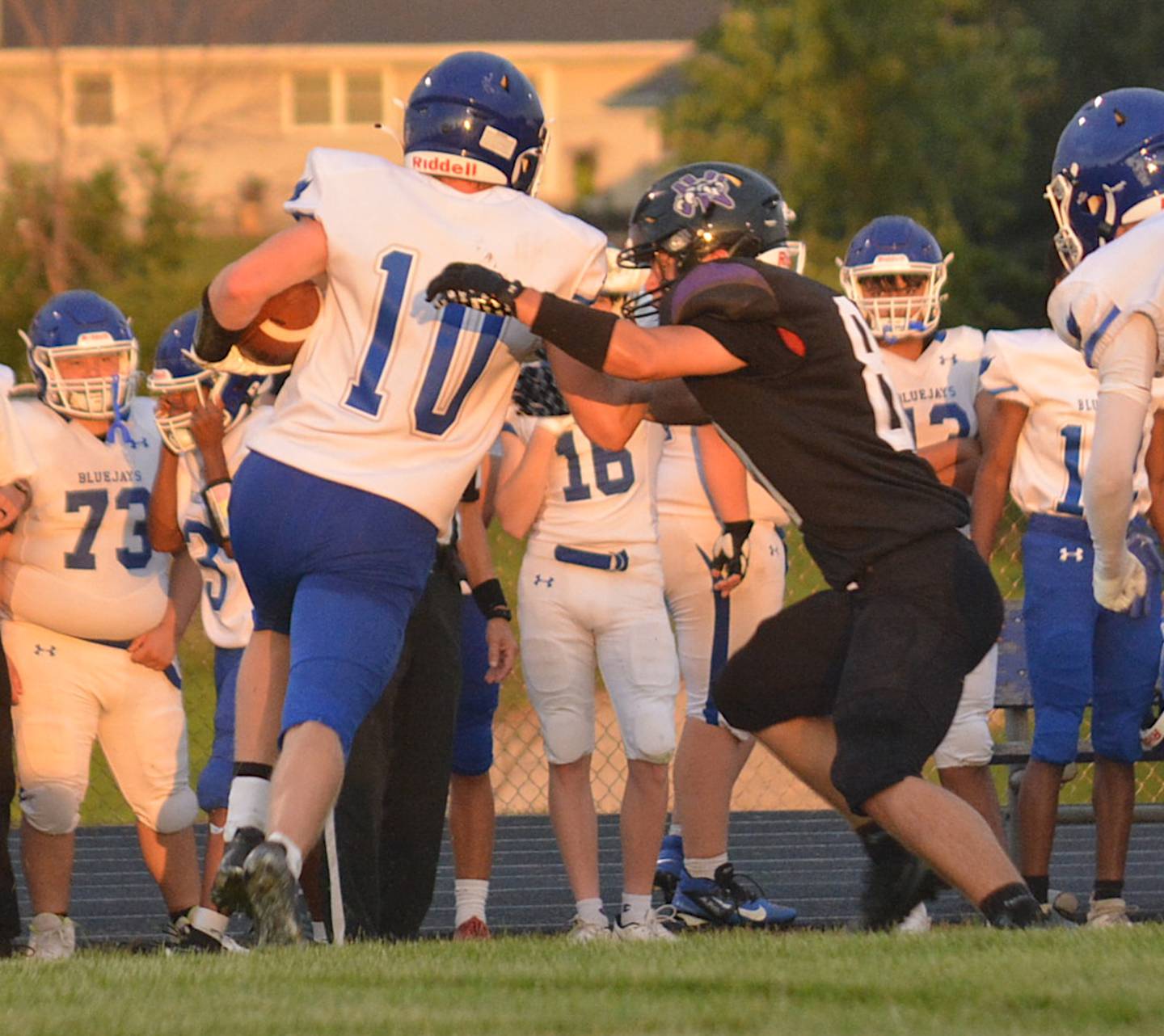 Wolverine senior Remington Woosley gets his paws on a Perry ball carrier last Friday night in a scrimmage in Greenfield.