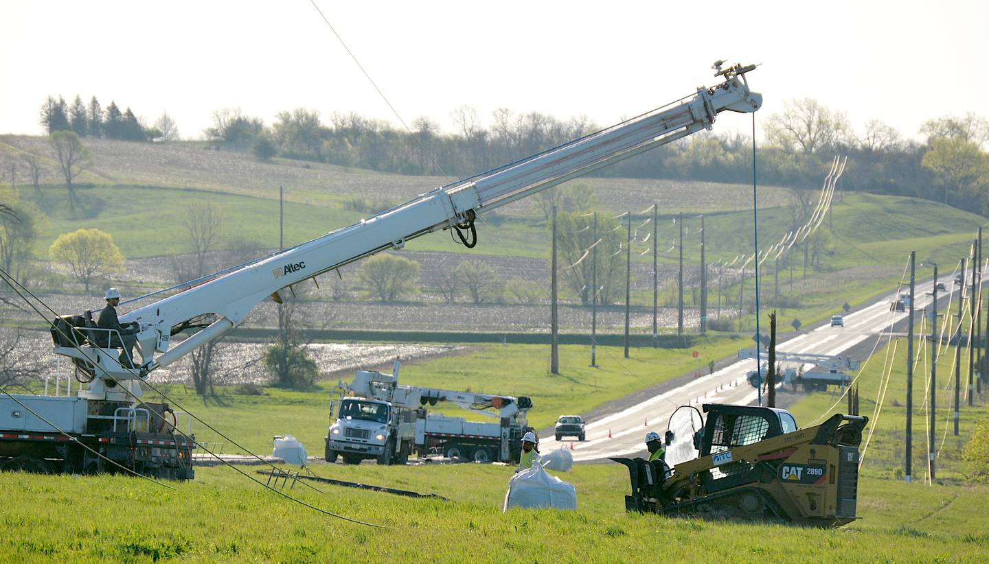 Electrical teams work on power lines along Highway 34 to restore power to surrounding areas.