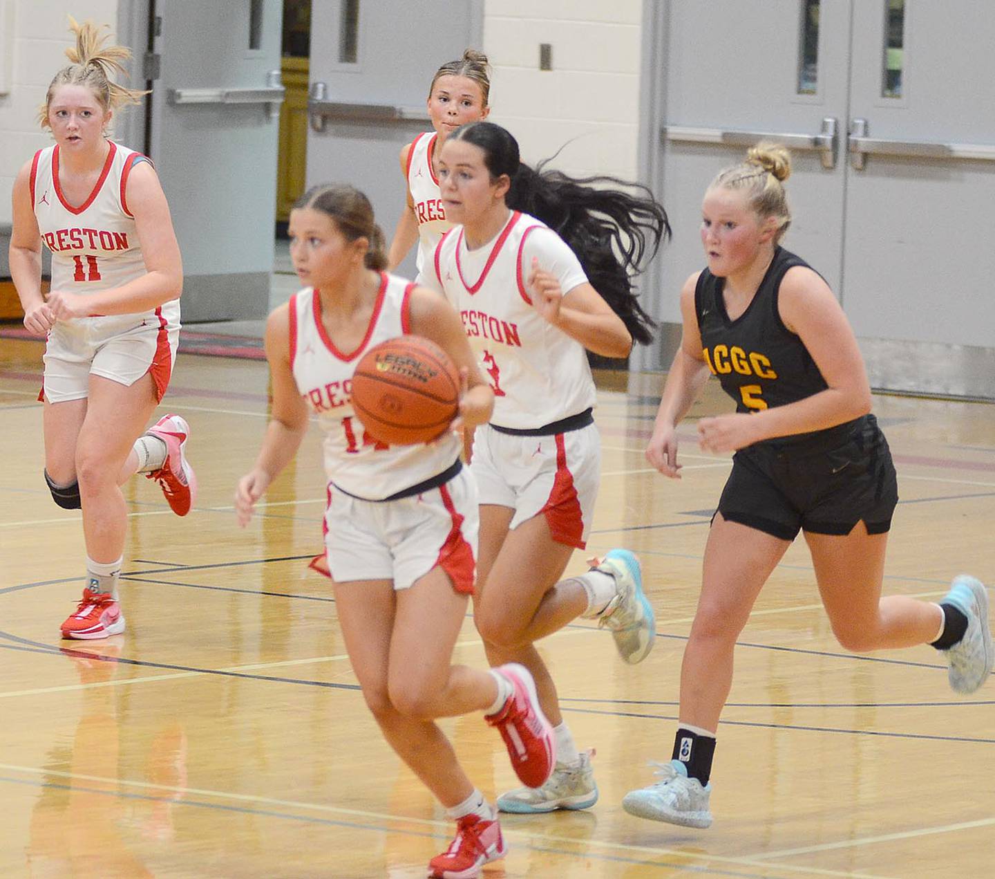 Freshman guard Jensan Tussey (14) leads a Creston fast break Tuesday against ACGC. Other Panthers shown are Brynn Tussey (11), Ava Adamson and Braylee Pokorny (3).