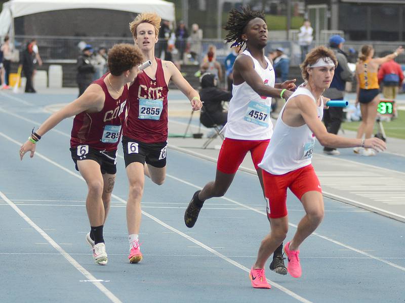 Southwestern anchor runner Chase Oates takes the baton from teammate Rouce Sayee during the men's college sprint medley relay Friday at the Drake Relays. The Spartans set a school record of 3:38.40 in placing 18th.