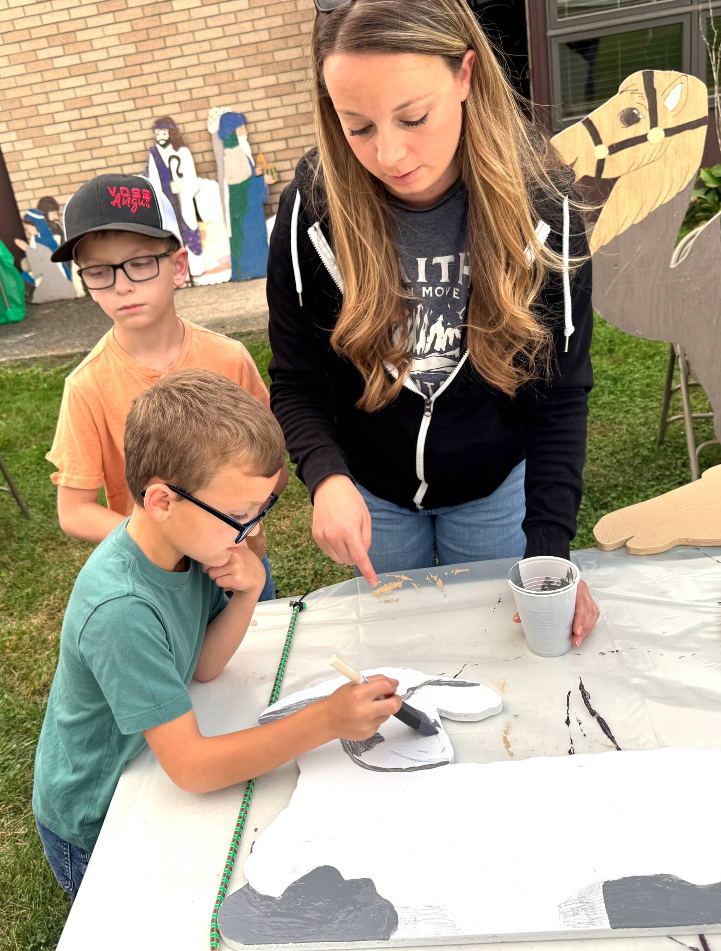 Members of the Orient Bulldogs 4-H Club paint new pieces of the new nativity scene at Orient United Methodist Church, where the club meets monthly.