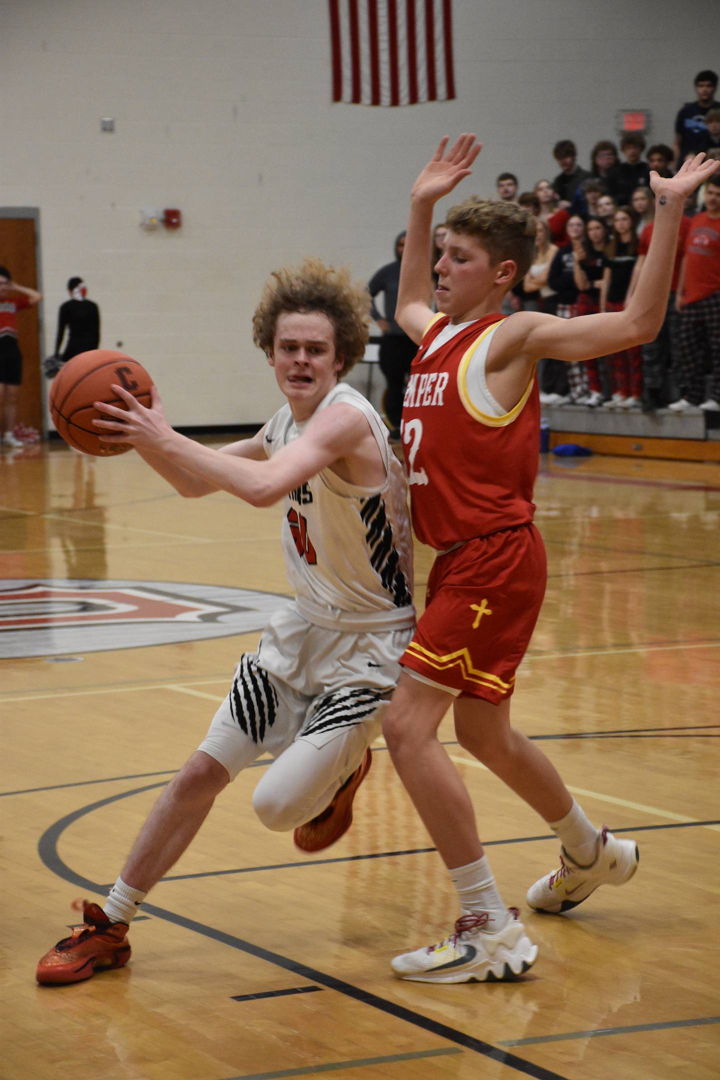 Creston's Ethan Crawford keeps himself between the ball and the Kuemper defender during Creston's loss Friday.