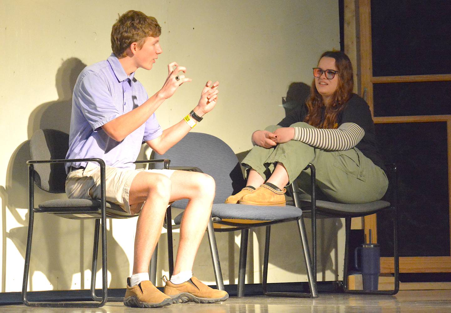 Brock Driskill, junior as Jared, and Reese Guiter, junior as Kassia, discuss what got them sent to the principal's office.