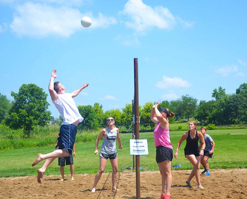 An athlete prepares to spike during the 2023 Annual Sand Volleyball Tournament.