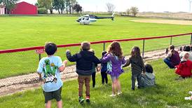 Orient helicopter pilot flies in to talk to students