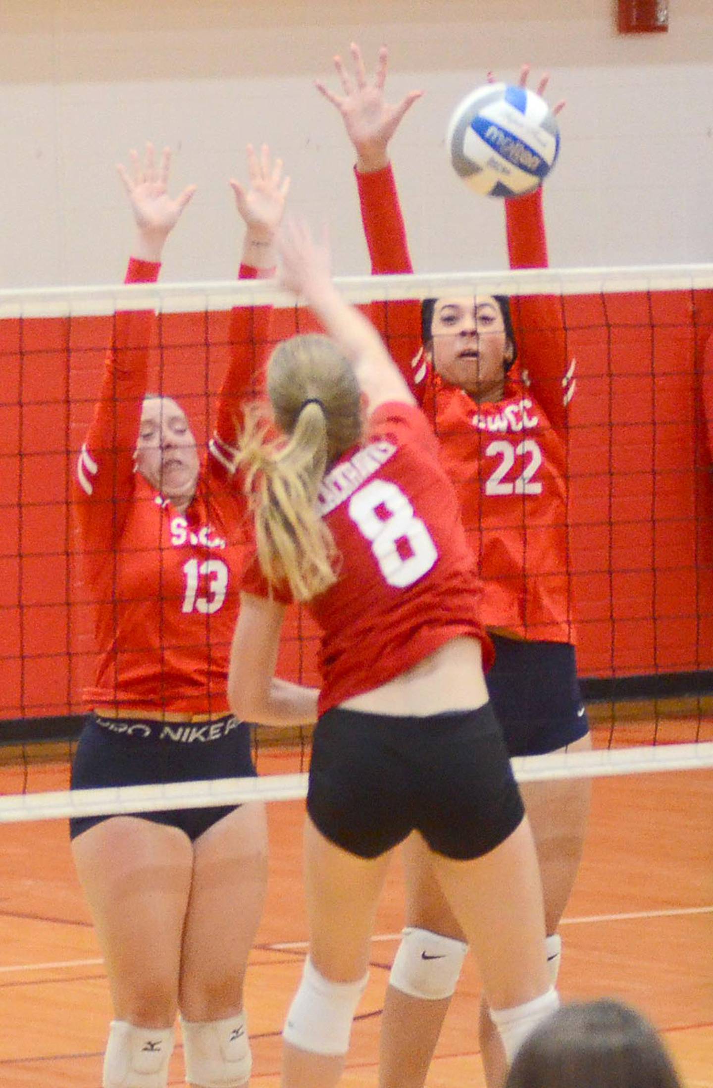 Whitney Hollins (22) and Cadence Perkins (13) of Southwestern reach for a block against Southeastern middle hitter Taryn Havener. Hollins had a team-high four solo blocks and two assisted blocks and added five kills in the loss.