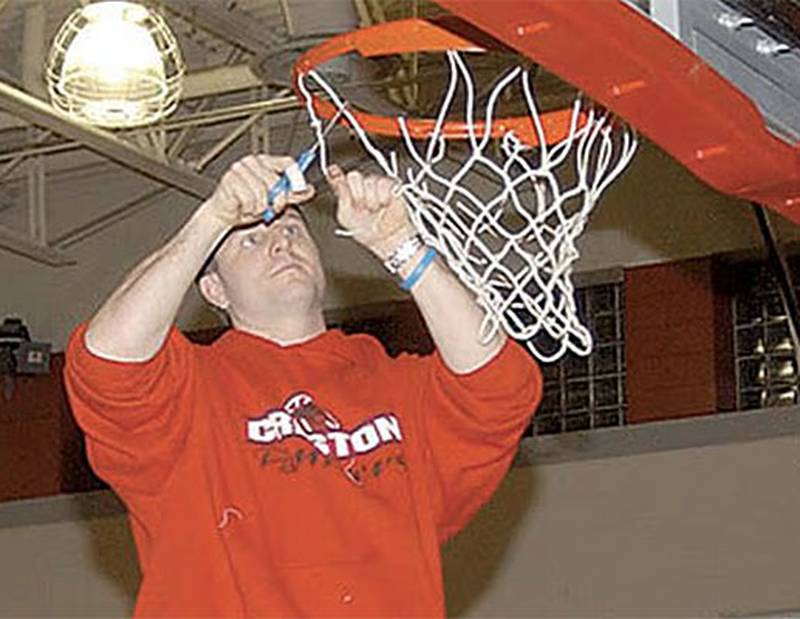 Creston coach Jim Calkins cuts down a portion of the net in the Creston gym after the Panthers defeated Albia in a 2006 substate final game in Indianola. The Panthers went on to place fourth in the state tournament, falling 42-42 to state champion Harlan in the semifinals and Grinnell in the third-place game to end a 21-5 season.