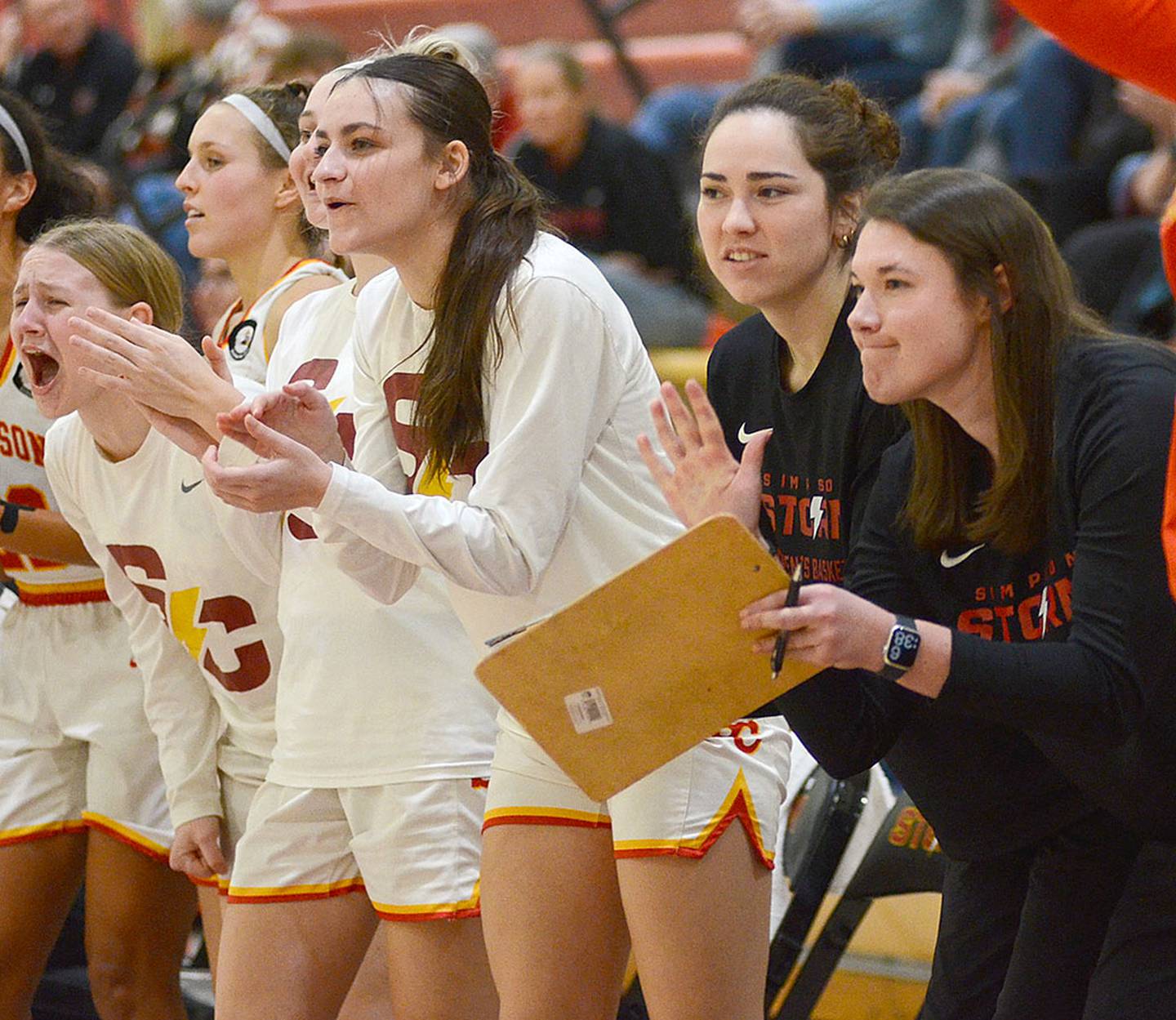 Former Simpson teammates Cameron Kincaid and Jenna Taylor (right) cheer on the Storm during Wednesday's home victory over Coe College. Taylor and Kincaid were starters on the 2022 Simpson team that won the American Rivers Conference and played in the NCAA Tournament.