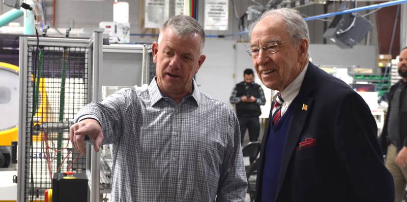 Precision Optical Group owner Mike Tamerius takes U.S. Senator Chuck Grassley on a tour of his laboratory Tuesday morning ahead of Grassley's Q&A with employees.