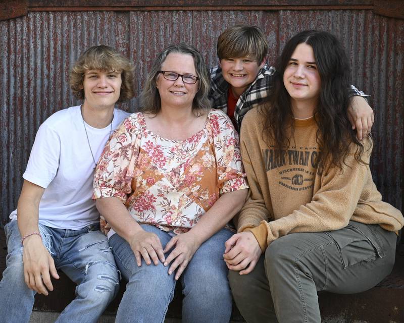 Jenny Moon has adopted two boys, along with her three biological children. From left: Austin Moon, 17; Jenny Moon; Skyler Little-Moon, 15; Joe Scarpello-Moon, 17.
