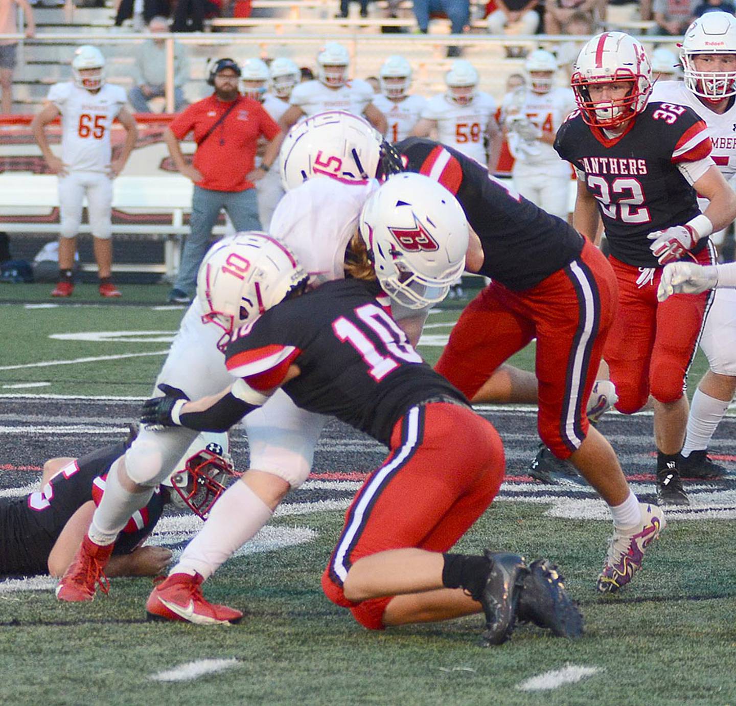 Creston defensive backs Dillon Starlin and McCoy Haines (15) tackle Ballard running back Eli Roush.