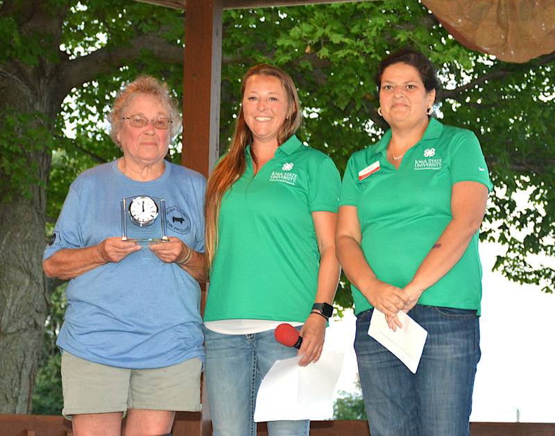 Grace Evans of Bridgewater, left, accepts induction into the Iowa 4-H Hall of Fame from ISU Extension Office staff Caroline Savage and Terri Raasch during July 10's opening ceremonies of the 2024 Adair County Fair.