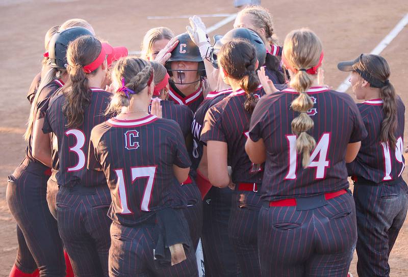 Teammates congratulate Creston's Mila Kuhns after her home run in the fifth inning to cut Dallas Center-Grimes' lead to 6-1. Kuhns had two hits in her final game for the Panthers.
