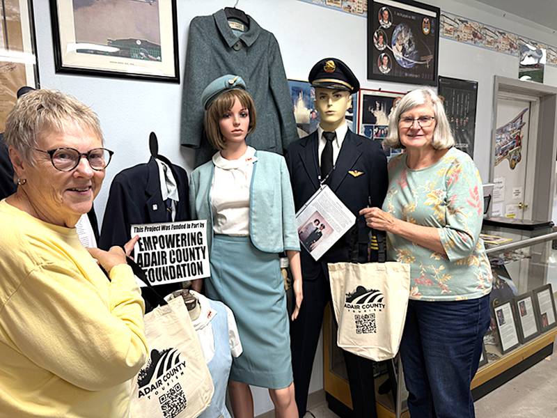 Mary Jensen and Helen Larson showcase cloth bags filled with promotional items for guests to the Iowa Aviation Museum, courtesy of the Adair County Tourism Board and paid for, in part, by the Empowering Adair County Foundation.
