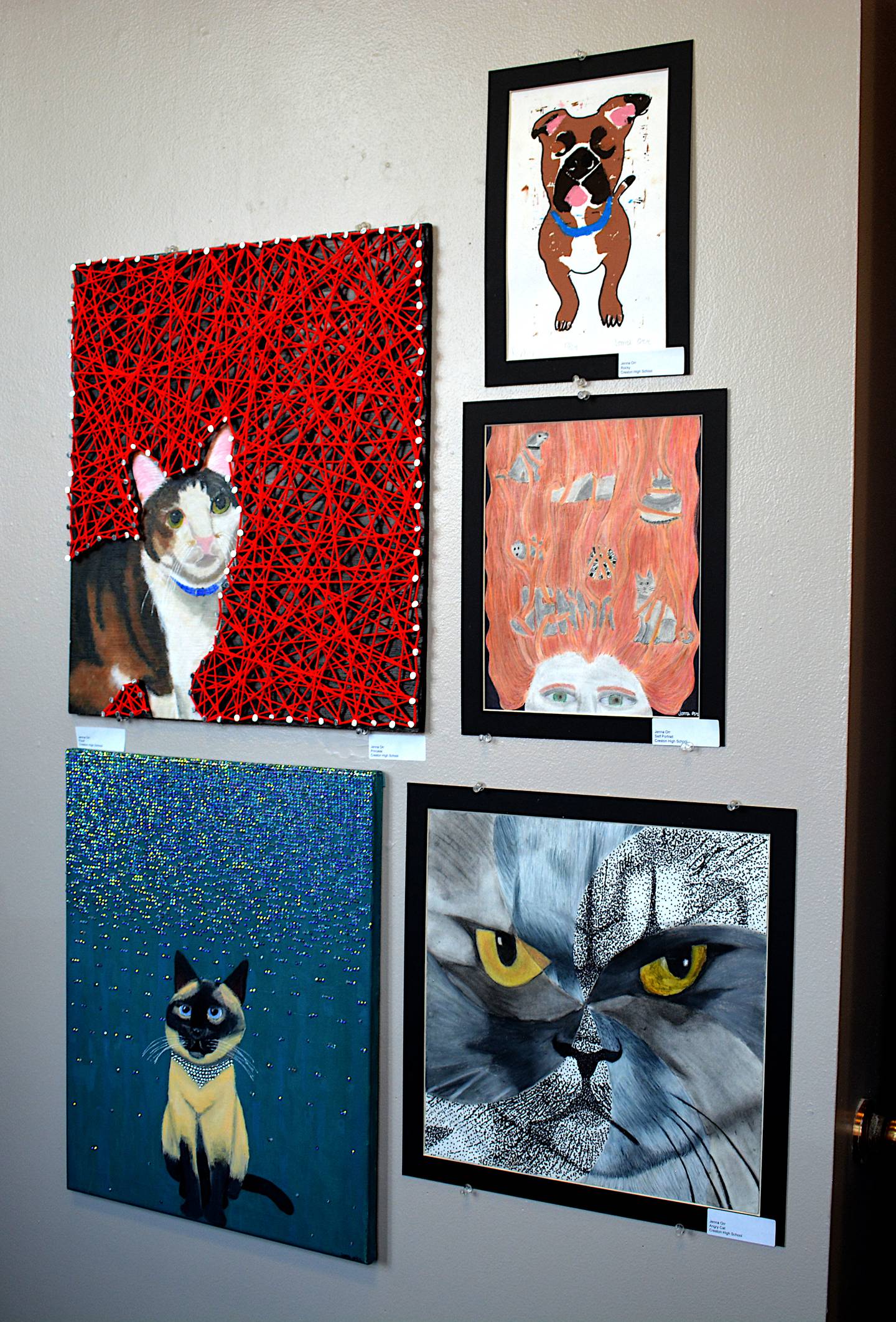 A collection of art pieces created by Jenna Orr with a central focus on cats.