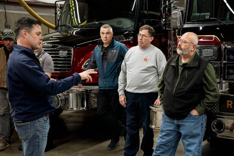 Supervisor Dennis Hopkins, Fire Chief Todd Jackson and Supervisor Rick Friday listen to U.S. Congressman Zach Nunn speak on Monday.