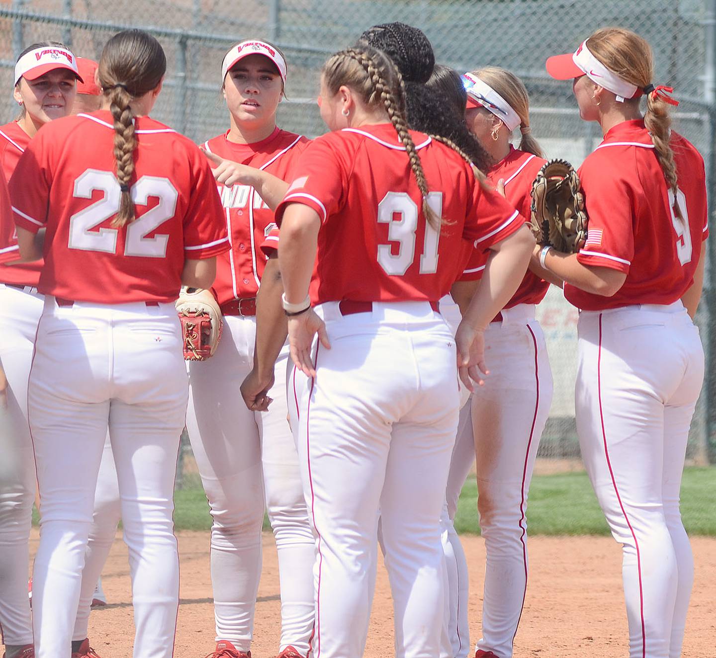Third baseman Nevaeh Randall talks to teammates after a defensive inning. Coach Lou A. Yacinich said Randall has taken on a leadership role in her third season with the Vikings.
