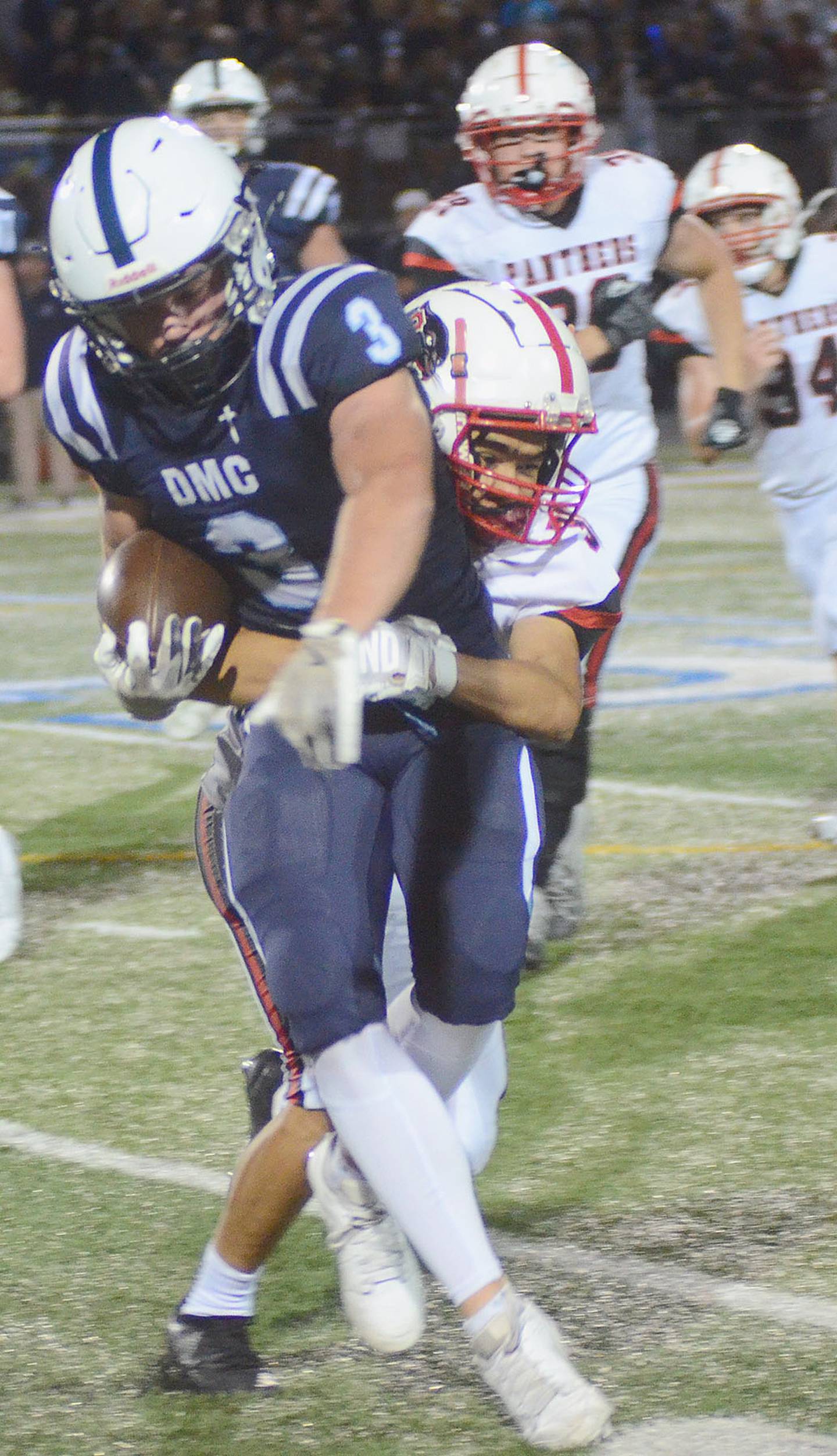 Creston defensive back David Sandoval tackles Des Moines Christian's Malachi Osborne after a pass reception.