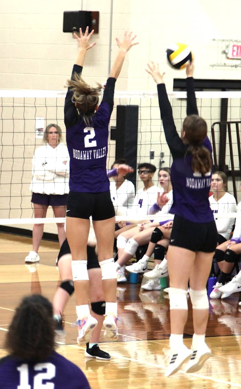 Nodaway Valley's Bailey Carstens (2) and Megan McCall (right) go up for a block in a match during the ACGC tournament Saturday, Sept. 16.