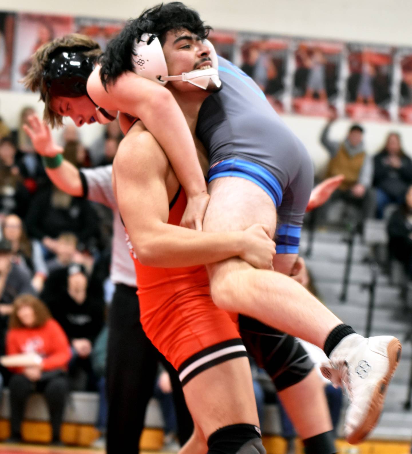 Jose Avila lifts Lewis Central's Layton Wright. Avila won the bout 10-8.
