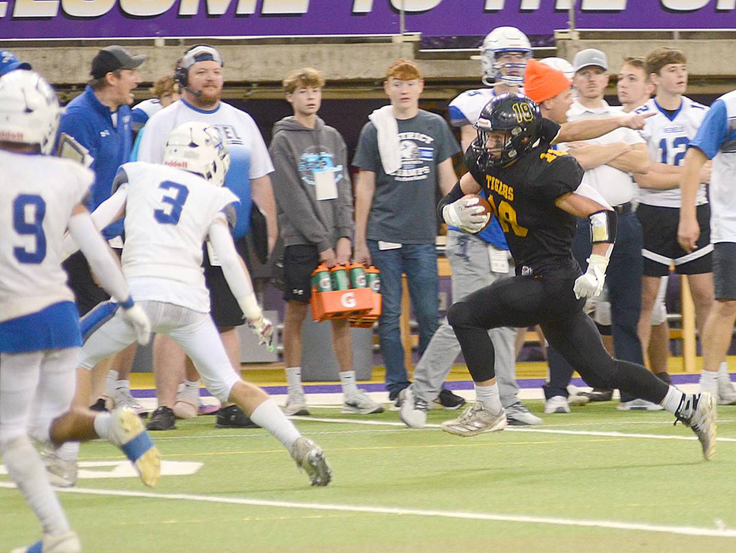 Lenox running back Jordan Martin-England (18) runs along the sideline on a sweep during Wednesday's semifinal game. Martin-England rushed for 106 yards and had three pass receptions for 20 yards along with 8.5 tackles for the Tiger defense in the 43-27 loss to Gladbrook-Reinbeck.