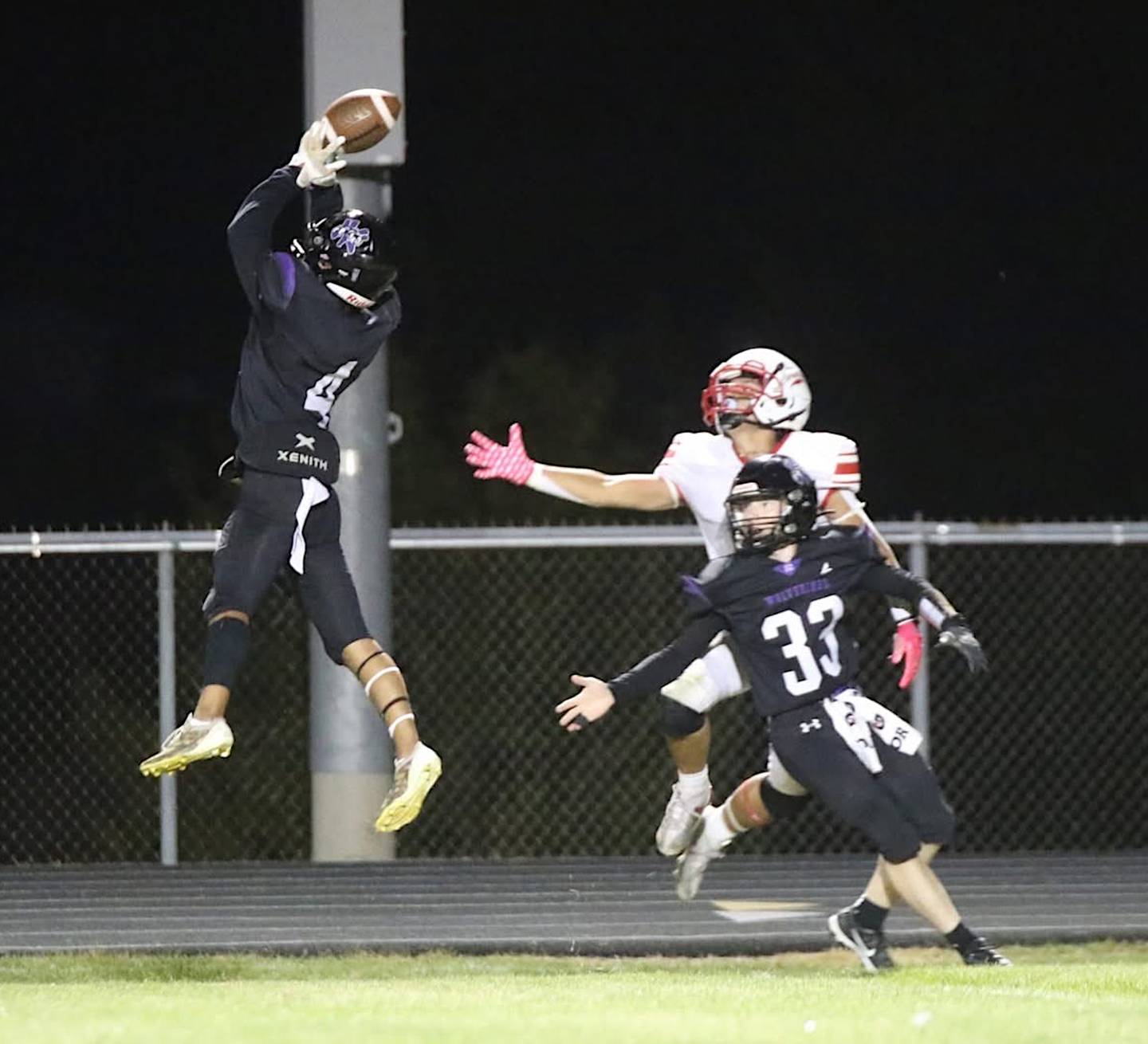 Wolverine senior Keyin Steeve (4) goes vertical for the ball against Central Decatur. Steeve had four catches and two interceptions on the night.