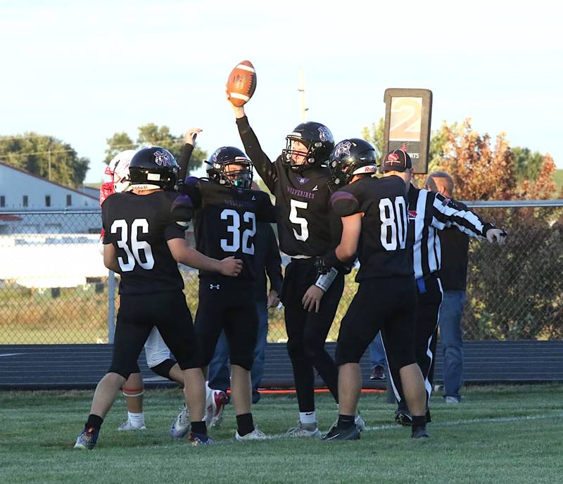 NV/OM quarterback Titan Foster (5) celebrates with teammates Mason Payne (36), Matthew Rudolf (32) and Remington Woosley (80) after a big play against Central Decatur.