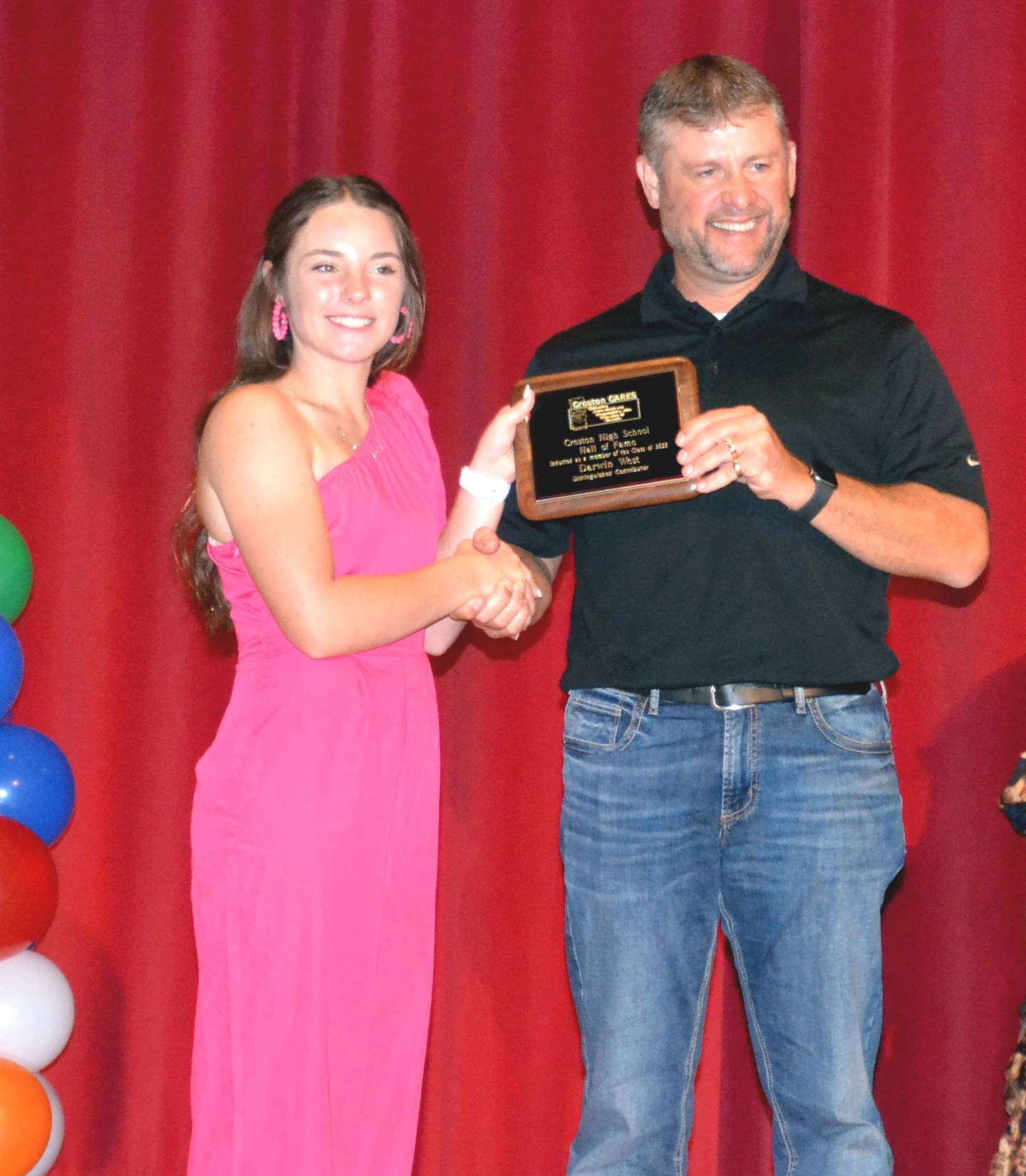 Lilly James presents the Darwin West's son, Rod West, his plaque for hall of fame contributor.